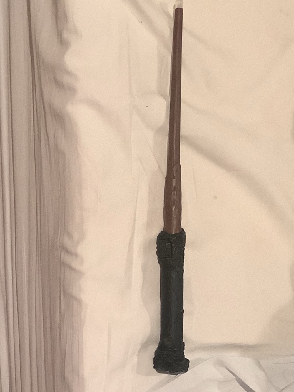 Handheld Brown Wand with Black Grip